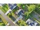 Aerial view of a home with a gray roof and white siding amid manicured lawns and lush green trees at 72 Cokesbury Park Ln, Fuquay Varina, NC 27526