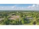 Expansive aerial view showcasing a mix of farmland, residential areas, and lush greenery under a bright, cloudy sky at 72 Cokesbury Park Ln, Fuquay Varina, NC 27526