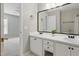 Bright bathroom featuring a double vanity with undermount sinks and modern fixtures at 72 Cokesbury Park Ln, Fuquay Varina, NC 27526