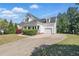 Charming two-story home with a covered front porch, attached garage, and well-manicured landscaping at 72 Cokesbury Park Ln, Fuquay Varina, NC 27526