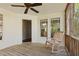 Inviting screened porch features a rocking chair and neutral finishes at 72 Cokesbury Park Ln, Fuquay Varina, NC 27526