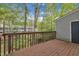 Outdoor balcony with wooden railings offering tree views at 7383 Sandy Creek Dr, Raleigh, NC 27615