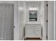 Bright bathroom with white subway tile, white vanity, and wood-look floors at 7383 Sandy Creek Dr, Raleigh, NC 27615