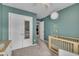 Bedroom room with a crib, changing table, neutral walls, and walk-in closet at 7383 Sandy Creek Dr, Raleigh, NC 27615