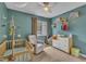 Comfortable Bedroom room featuring a crib, chair, changing table, and natural light at 7383 Sandy Creek Dr, Raleigh, NC 27615