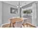 Cozy dining room with a wooden table, four chairs, and a window with natural light at 7383 Sandy Creek Dr, Raleigh, NC 27615