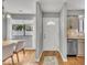 Open entryway with hardwood floors, leading to dining area and kitchen with stainless steel appliances at 7383 Sandy Creek Dr, Raleigh, NC 27615
