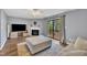 Bright living room featuring a fireplace, TV and outdoor access to the balcony at 7383 Sandy Creek Dr, Raleigh, NC 27615
