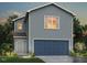 Charming two-story home features a blue garage door, gray siding, and well-maintained landscaping at 76 Landon Pl, Roxboro, NC 27573
