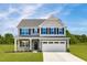 Charming two-story home with gray siding, black shutters, and a well-manicured front lawn at 812 Walker Ridge Way, Willow Springs, NC 27592