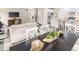 Open-concept living space with a dining area, couches, hardwood floors and large windows at 812 Walker Ridge Way, Willow Springs, NC 27592