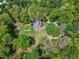 Aerial view of home featuring a well-manicured lawn, privacy, and mature trees at 8120 Stillbreeze Dr, Fuquay Varina, NC 27526