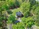 Aerial view of brick home surrounded by mature trees and a manicured lawn at 8120 Stillbreeze Dr, Fuquay Varina, NC 27526