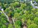 Aerial shot showcases a home nestled among lush trees at 8120 Stillbreeze Dr, Fuquay Varina, NC 27526