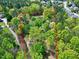 Aerial shot of a property featuring lush trees outlined in a red boundary at 8120 Stillbreeze Dr, Fuquay Varina, NC 27526
