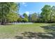 Expansive backyard featuring a mature tree and a charming white picket fence surrounding the property at 8120 Stillbreeze Dr, Fuquay Varina, NC 27526