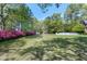 Lush backyard with vibrant azaleas and plenty of green space at 8120 Stillbreeze Dr, Fuquay Varina, NC 27526