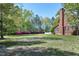 Extensive backyard with azaleas and partial view of a brick home at 8120 Stillbreeze Dr, Fuquay Varina, NC 27526