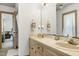 Bright bathroom features a double sink vanity, a large mirror, and tile flooring at 8120 Stillbreeze Dr, Fuquay Varina, NC 27526