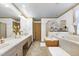 A spacious bathroom with a shower, a jacuzzi tub, double sinks, and tile flooring at 8120 Stillbreeze Dr, Fuquay Varina, NC 27526