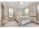 Light-filled bedroom with soft carpet, three windows, and decorative accents at 8120 Stillbreeze Dr, Fuquay Varina, NC 27526