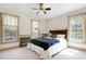 Cozy bedroom with a ceiling fan and natural light from the multiple windows at 8120 Stillbreeze Dr, Fuquay Varina, NC 27526