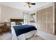This bedroom features a ceiling fan, a built-in bookcase, and neutral carpet at 8120 Stillbreeze Dr, Fuquay Varina, NC 27526