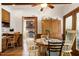 Dining room with hardwood floors, a rustic table, upholstered chairs, and access to the living room at 8120 Stillbreeze Dr, Fuquay Varina, NC 27526