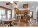 Eat-in kitchen with wood cabinets, hardwood floors, and plenty of natural light at 8120 Stillbreeze Dr, Fuquay Varina, NC 27526