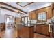 Spacious kitchen with center island, wood cabinets and hardwood floors, open to other rooms at 8120 Stillbreeze Dr, Fuquay Varina, NC 27526