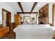 Spacious living room boasts exposed beams, brick fireplace, and comfortable, inviting furniture at 8120 Stillbreeze Dr, Fuquay Varina, NC 27526