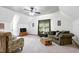 Open living area with vaulted ceilings, cozy seating, carpet, and a ceiling fan at 8120 Stillbreeze Dr, Fuquay Varina, NC 27526
