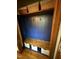A mudroom with blue wood paneling, a wooden bench, white storage cubes, baskets, and four hooks at 8120 Stillbreeze Dr, Fuquay Varina, NC 27526