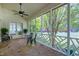 Inviting screened porch with brick floors, a ceiling fan, and picturesque views of the landscaped backyard at 8120 Stillbreeze Dr, Fuquay Varina, NC 27526