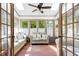 Bright sunroom featuring skylights, a ceiling fan, and comfortable seating for relaxation at 8120 Stillbreeze Dr, Fuquay Varina, NC 27526