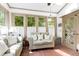 Charming sunroom with terracotta tile, comfortable seating and abundant natural light at 8120 Stillbreeze Dr, Fuquay Varina, NC 27526