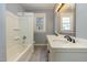 Bright bathroom featuring double sinks and tub with shower at 813 S Franklin St, Rocky Mount, NC 27803