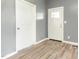 Light-filled entryway featuring modern gray walls and durable laminate flooring at 813 S Franklin St, Rocky Mount, NC 27803