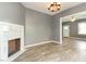 Bright living room featuring a decorative fireplace and wood-look floors at 813 S Franklin St, Rocky Mount, NC 27803