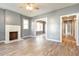 Bright living room featuring a decorative fireplace, neutral paint, and modern laminate flooring at 813 S Franklin St, Rocky Mount, NC 27803