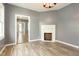 Inviting living room featuring a decorative fireplace and wood-look floors at 813 S Franklin St, Rocky Mount, NC 27803