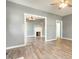 Open-concept room featuring a decorative fireplace, neutral walls, and modern laminate flooring at 813 S Franklin St, Rocky Mount, NC 27803