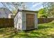 Exterior of a small, weathered shed in the backyard with vertical siding, and double wooden doors at 813 S Franklin St, Rocky Mount, NC 27803