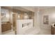 Modern bathroom with standalone tub, dual shower heads, and sleek vanity at 8413 Portmarnock Ct, Wake Forest, NC 27587