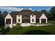 Stunning home with brick facade, dark trim and elegant landscaping provides privacy and curb appeal at 8413 Portmarnock Ct, Wake Forest, NC 27587