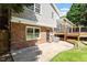 Backyard with a brick house, a patio, and a wooden deck with a pergola, perfect for entertaining or relaxing at 904 Emory Ln, Raleigh, NC 27609