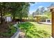 Landscaped backyard with a pergola, a wooden deck with an outdoor fireplace, and a storage shed at 904 Emory Ln, Raleigh, NC 27609