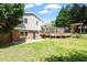 A charming home featuring a spacious backyard, beautiful deck, and brick accents, perfect for outdoor relaxation and entertaining at 904 Emory Ln, Raleigh, NC 27609