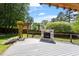 Backyard featuring a wooden deck with an outdoor fireplace and a pergola covered with climbing vines at 904 Emory Ln, Raleigh, NC 27609