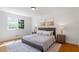 Comfortable bedroom featuring a large bed with a gray headboard, matching nightstands, and a window with bright sunlight at 904 Emory Ln, Raleigh, NC 27609